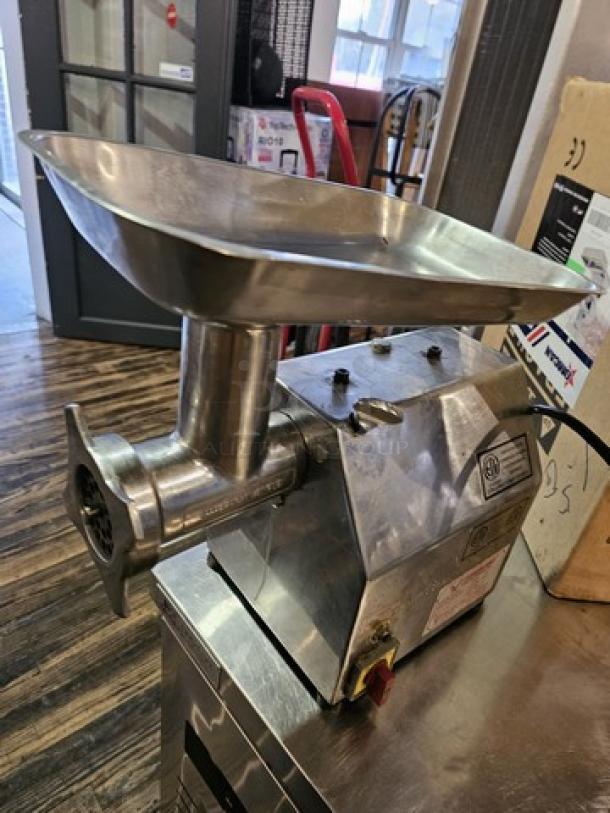 Stainless steel meat grinder MG-IT-0022-C 115V with tray, sturdy build, power switch visible, used condition.