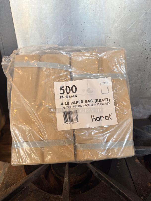 Pack of 500 Karat kraft paper bags, 4 lb capacity, dimensions 5x3.03x9.45 inches, new in plastic wrap.