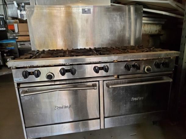 Garland SunFire 60" liquid propane gas range with 10 burners, two standard ovens. Visible wear, "SunFire" logo on ovens.
