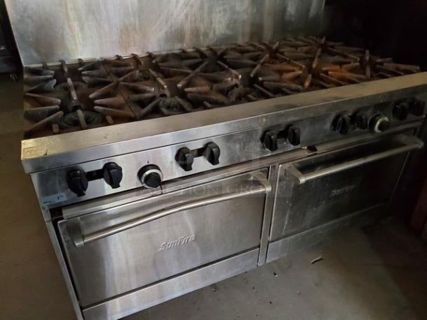 Garland SunFire 10 burner 60" liquid propane gas range with two standard ovens. Stainless steel, used condition, visible SunFire logo.