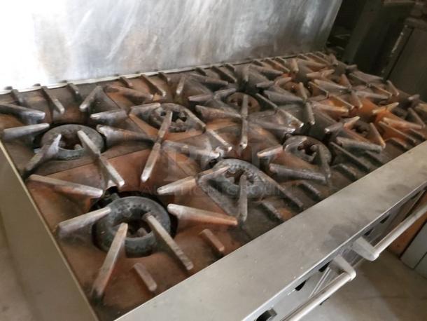 Garland SunFire 60" 10-burner gas range with dual ovens, liquid propane. Used condition with visible wear on burners.