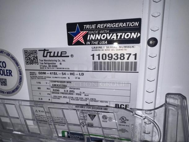 TRUE GDM-41SL two-door cooler merchandiser label, model and serial number visible, features energy efficiency details.