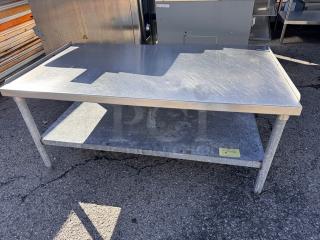 53 1/2" stainless steel stand with lower shelf, slightly worn surface, ideal for kitchen or commercial use.