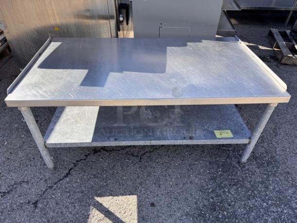 53 1/2" stainless steel stand with a two-tier design, showcasing a polished top surface and lower shelf, in used condition.