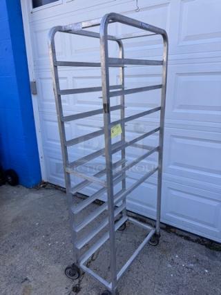 Aluminum pan rack with multiple shelves, good condition, caster wheels for mobility, suitable for commercial kitchens.