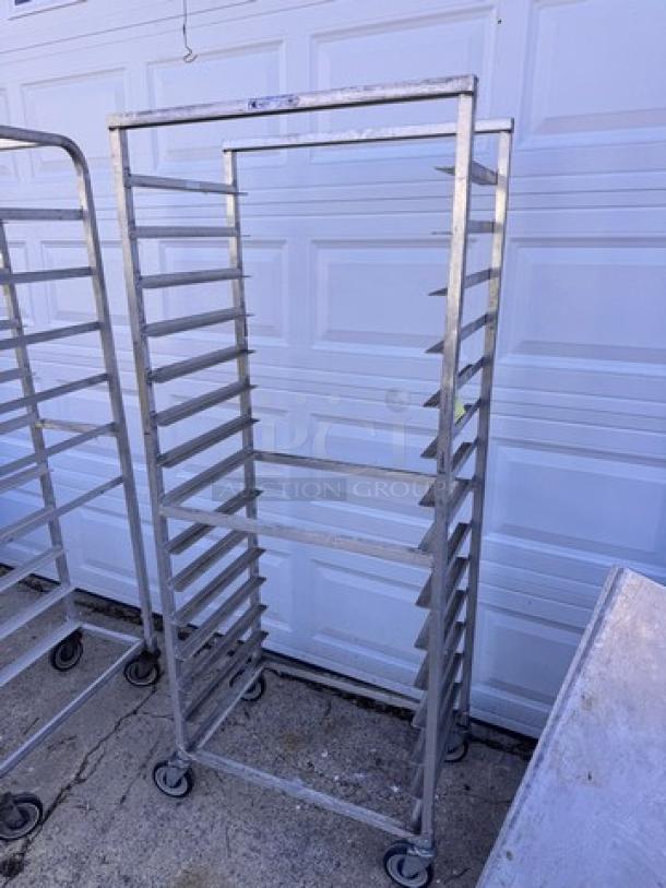 Aluminum pan rack with 10 slots, on wheels, suitable for commercial kitchens; good condition.