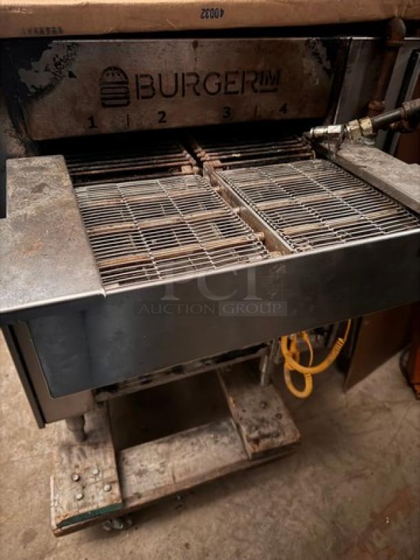 Burger IM commercial grill, features dual cooking grates, steel construction, visible wear, markings emphasize brand logo.