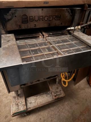 Burger IM commercial grill, features dual cooking grates, steel construction, visible wear, markings emphasize brand logo.