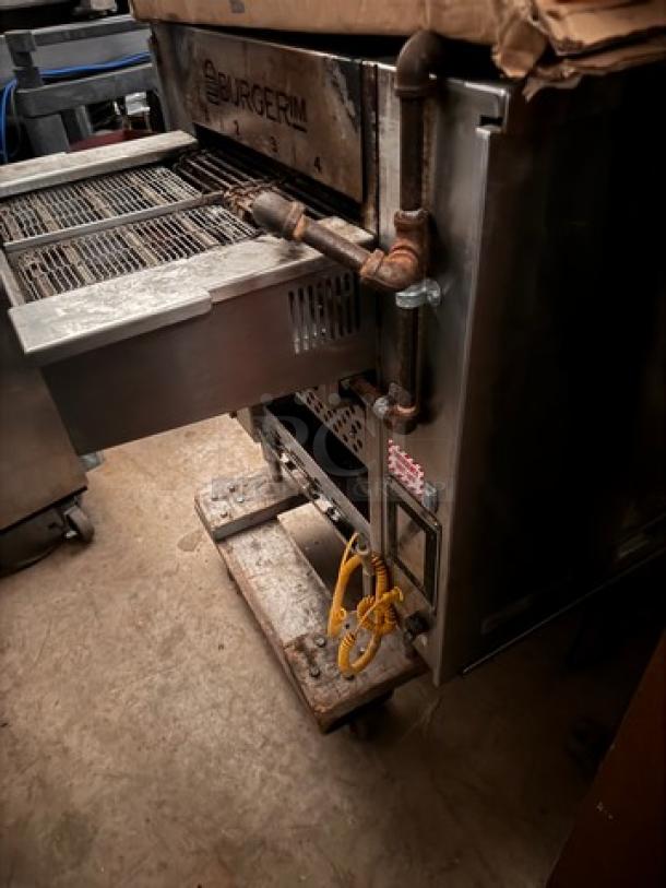 Burger IM commercial grill, stainless steel, used condition, with adjustable racks and visible power connections.