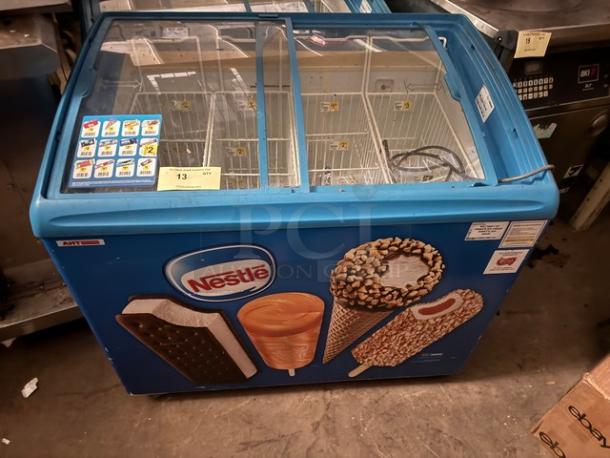 AHT RIO S 100 sliding glass top ice cream freezer merchandiser with Nestlé branding, blue exterior, good condition.
