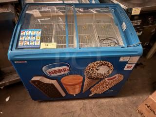 AHT RIO S 100 sliding glass top ice cream freezer merchandiser with Nestlé branding, blue exterior, good condition.