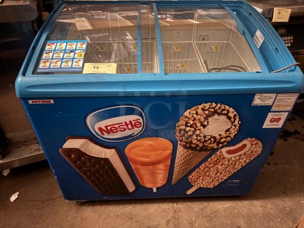 AHT RIO S 100 sliding glass top ice cream freezer merchandiser with Nestlé branding, used condition, visible pricing labels.
