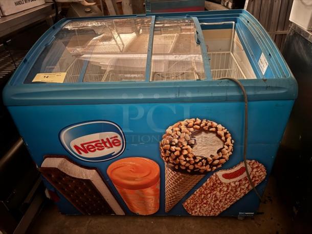 AHT RIO S 100 F ice cream freezer with sliding glass top, Nestlé branding, vibrant graphics, and visible product compartments.