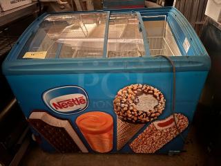 AHT RIO S 100 F ice cream freezer with sliding glass top, Nestlé branding, vibrant graphics, and visible product compartments.