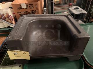 Black booster seat with a contoured design, showing minor wear. Includes label indicating quantity and auction details.