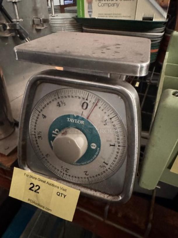 Vintage TAYLOR mechanical kitchen scale with 22 lb capacity, metallic finish, visible wear, and clear dial markings.