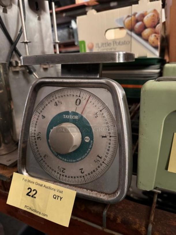 TAYLOR kitchen scale in metal casing with a round dial, showing weight in pounds and kilograms, in used condition.