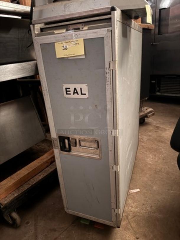 EAL airline galley cart, metal construction, features latch handle, visible "EAL" label, moderate wear.