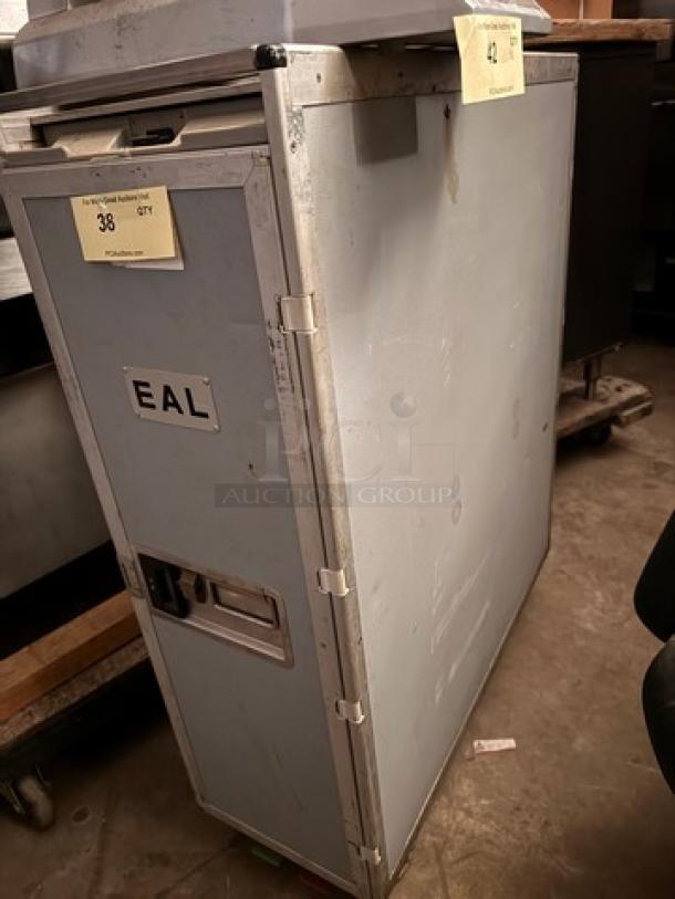 Vintage EAL airline service cart, grey with signs of wear, visible EAL label, metal construction, suitable for collectors.