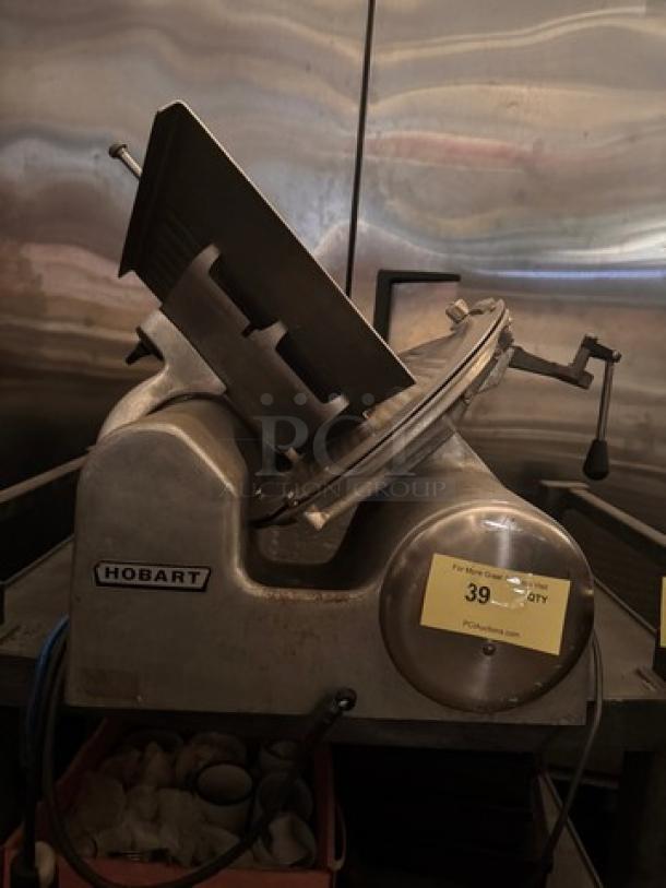 Hobart 1612E Meat Slicer, 115V, features stainless steel build, labeled with Hobart logo, used condition.