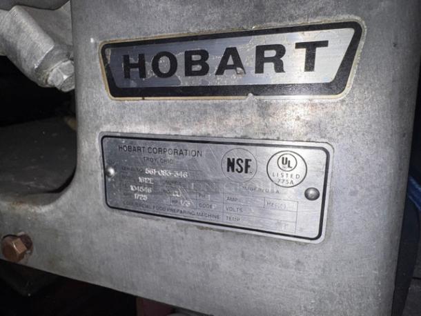 Hobart 1612E meat slicer in silver, featuring NSF and UL labels with specifications, model 1612E, 115V.