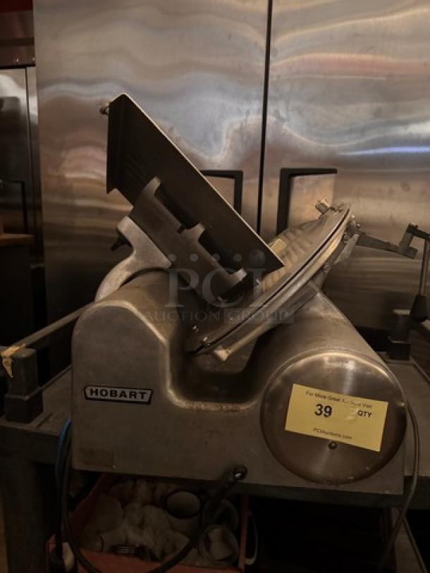 Hobart 1612E Meat Slicer, 115V, stainless steel, used condition, visible Hobart label, includes item tag indicating quantity 39.