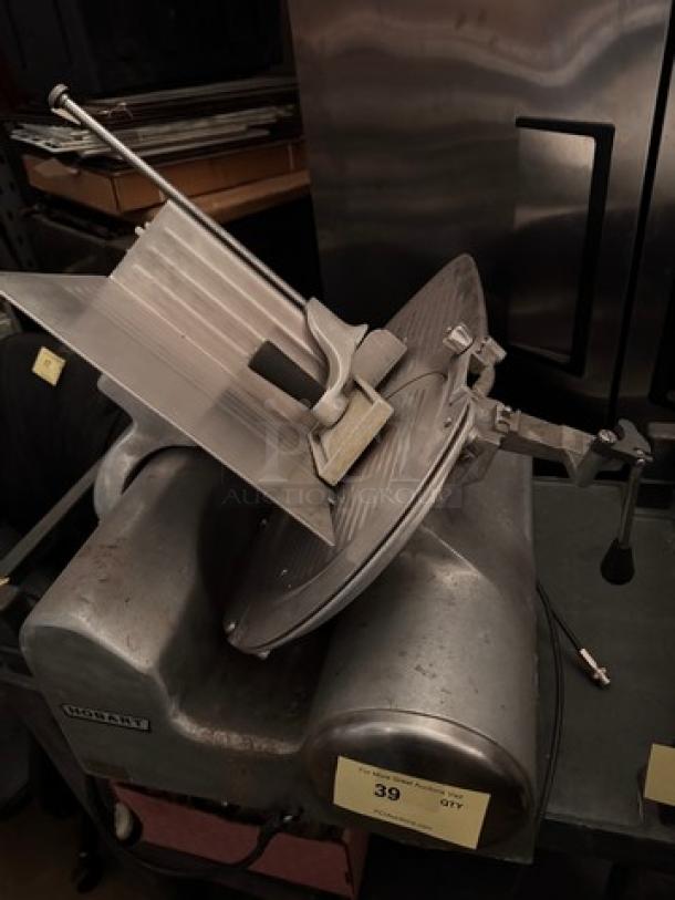 Hobart 1612E meat slicer, model 1612E, 115V. Features sturdy construction, blade guard, adjustable thickness. Used condition.