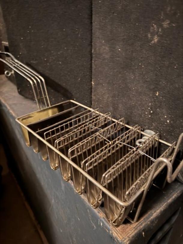 Stainless steel taco fryer basket with multiple slots, used condition, designed for commercial kitchen use.