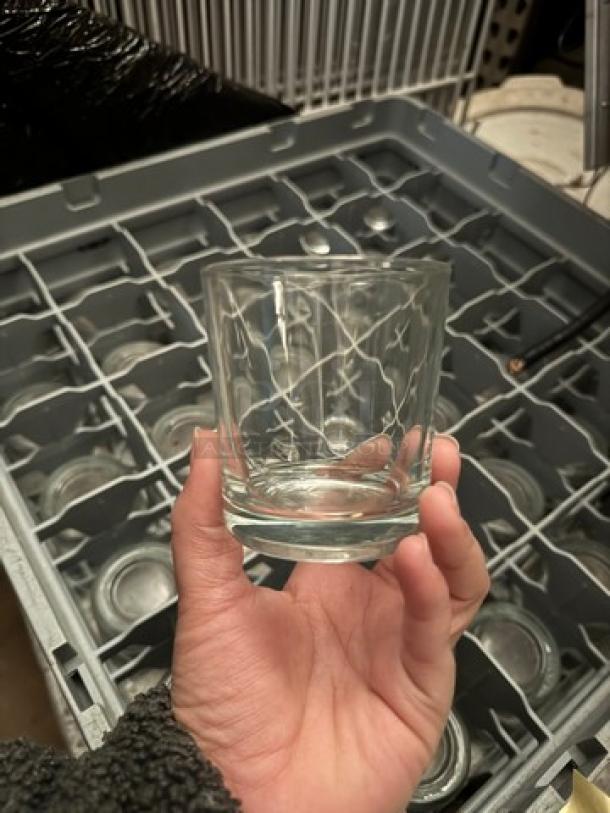 Glass rack filled with matching etched glasses, good condition, all for one price, in dishwasher rack.