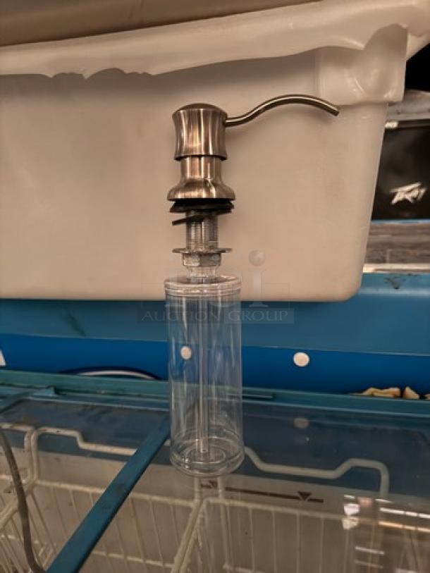 Clear glass bottle dispenser BIDX5 with stainless steel pump, excellent condition. Suitable for kitchen or bathroom use.