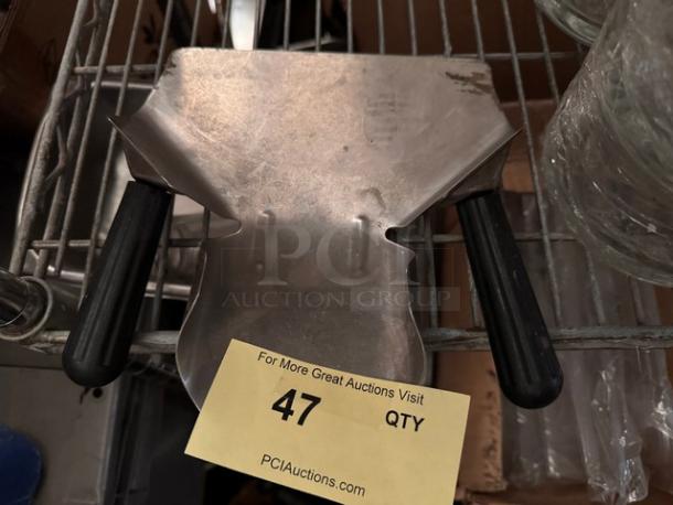 Dual handle French fry scoop, stainless steel, black grips, slightly used with minor scuffs, auction tag number 47 visible.
