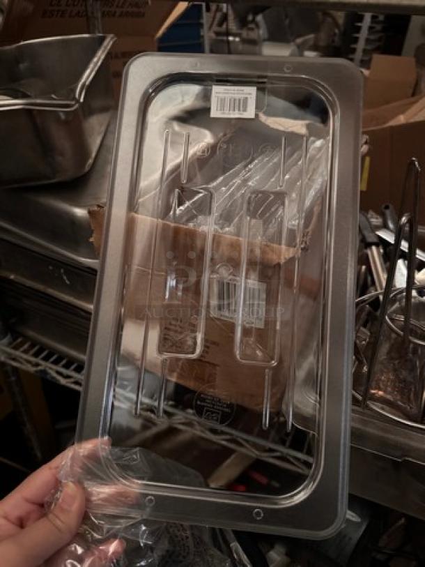 Brand new clear plastic lid for food pan, rectangular shape, with BIDX9 label and barcode, in pristine condition.