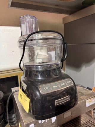 KitchenAid food processor with black base, clear plastic bowl, and control panel showing Off, Low, High, Pulse options.