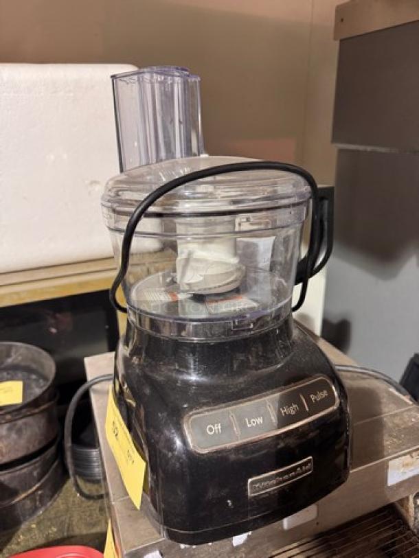 KitchenAid food processor, black, with control buttons: Off, Low, High, Pulse. Visible wear. Suitable for various food prep tasks.