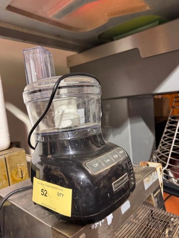 KitchenAid food processor in black with control buttons; includes lid and feed tube. Shows yellow auction tag marked "52 QTY."