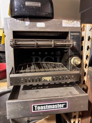 Toastmaster commercial conveyor toaster, metal finish, visible wear, adjustable controls, branded label on front.