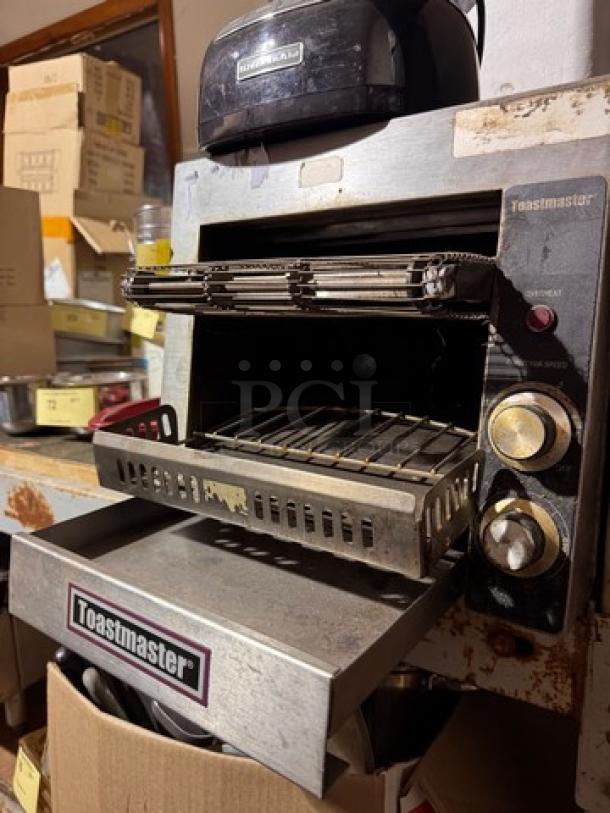 Toastmaster commercial conveyor toaster, black and silver, visible brand logo, dials for settings, used condition.