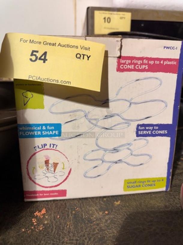 Box of Cone Caddy with whimsical flower shape design, fits sugar and plastic cone cups. Some wear on packaging.