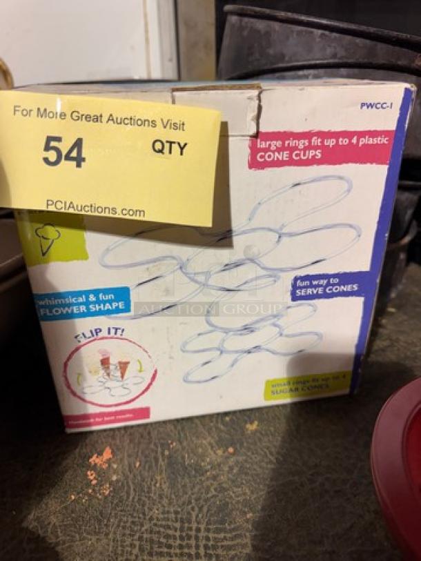 Cone Caddy box with flower shape design, holds four plastic cone cups. Marked as whimsical and fun. Slight box wear visible.