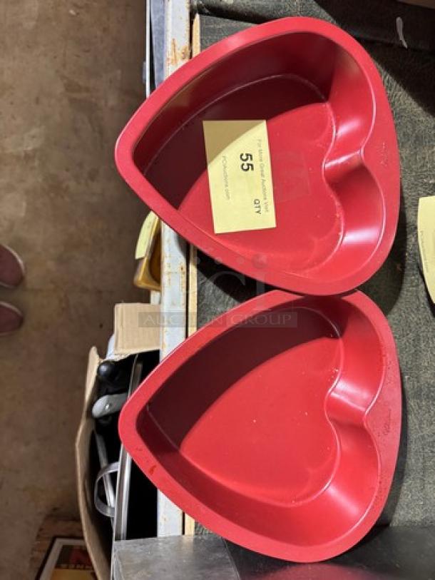 Two red heart-shaped baking pans, model BIDX2, in good condition, with auction tag indicating item 55.