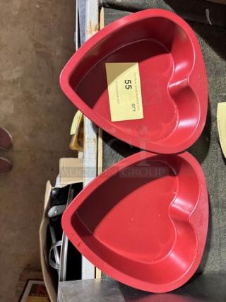 Two red heart-shaped baking pans, model BIDX2, in good condition, with auction tag indicating item 55.