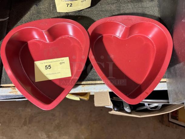 Heart-shaped red baking pans, set of two, slightly used condition. Auction tag reads "55 QTY", indicating batch number.