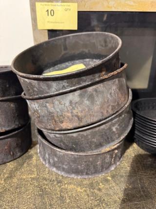 Rustic metal baking pan stack, model BIDX4, showing signs of wear and patina. Auction lot labeled "10 QTY."