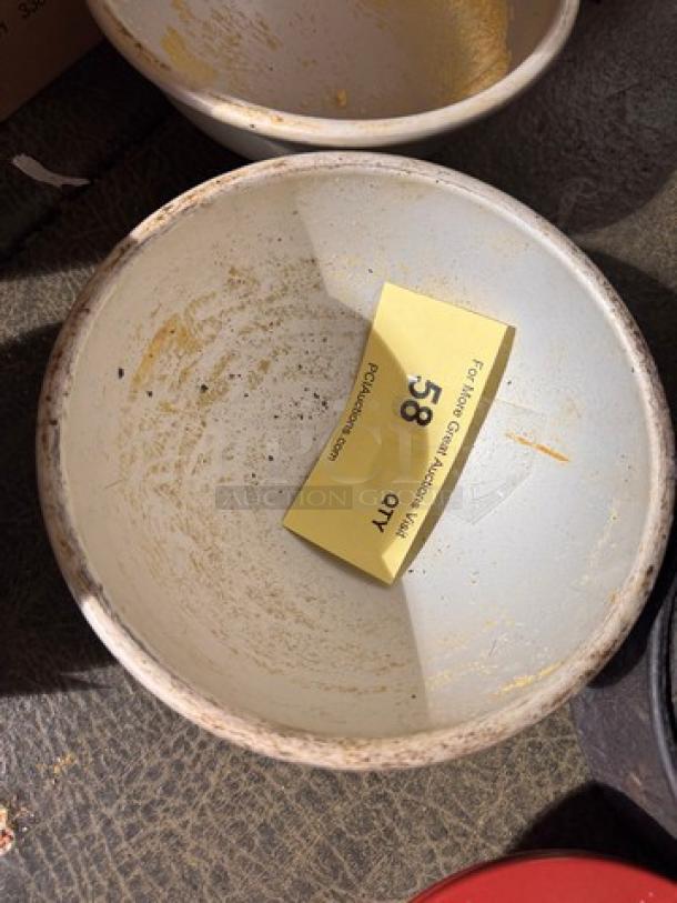 White round baking pan labeled "58 QTY" with signs of use; interior shows baking residue and wear.