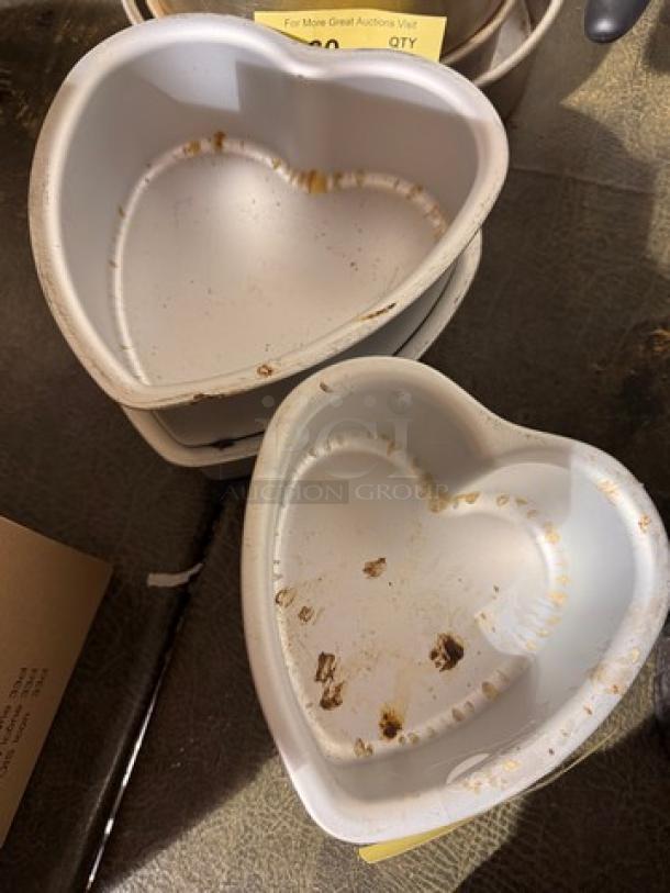 Heart-shaped baking pans, set of two, used condition with food residue, model BIDX4, suitable for themed baking.