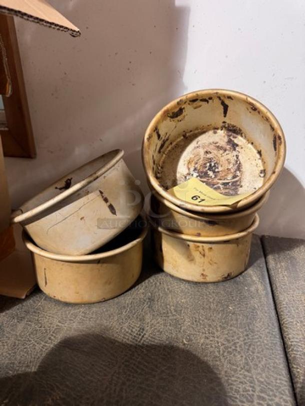 Set of four vintage BIDX5 baking pans, showing signs of wear and discoloration. A small numbered tag is visible inside one pan.