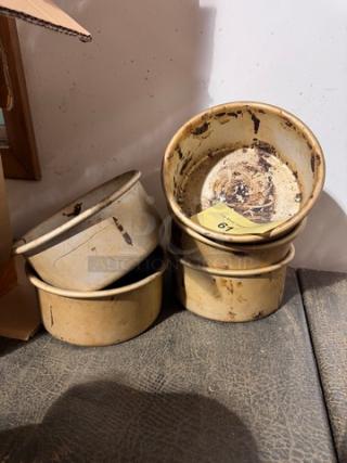 Set of four vintage BIDX5 baking pans, showing signs of wear and discoloration. A small numbered tag is visible inside one pan.