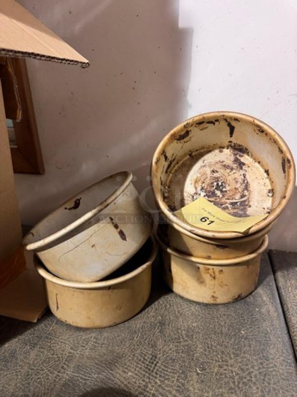 Vintage ceramic baking pans, four stacked, worn condition, visible stains and chipping, labeled "BIDX5," auction item 67.