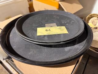 Black trays stacked on cardboard box. Yellow label indicates auction lot 64. Condition shows visible wear.