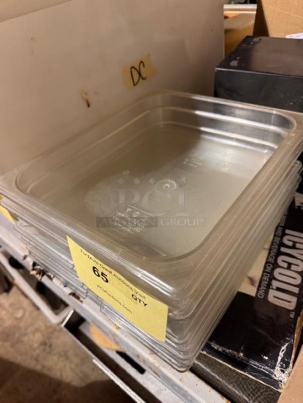 Stack of clear 1/2x2.5 inch plastic food pans, model BIDX7; shown with quantity labels on shelf, suitable for kitchen storage.